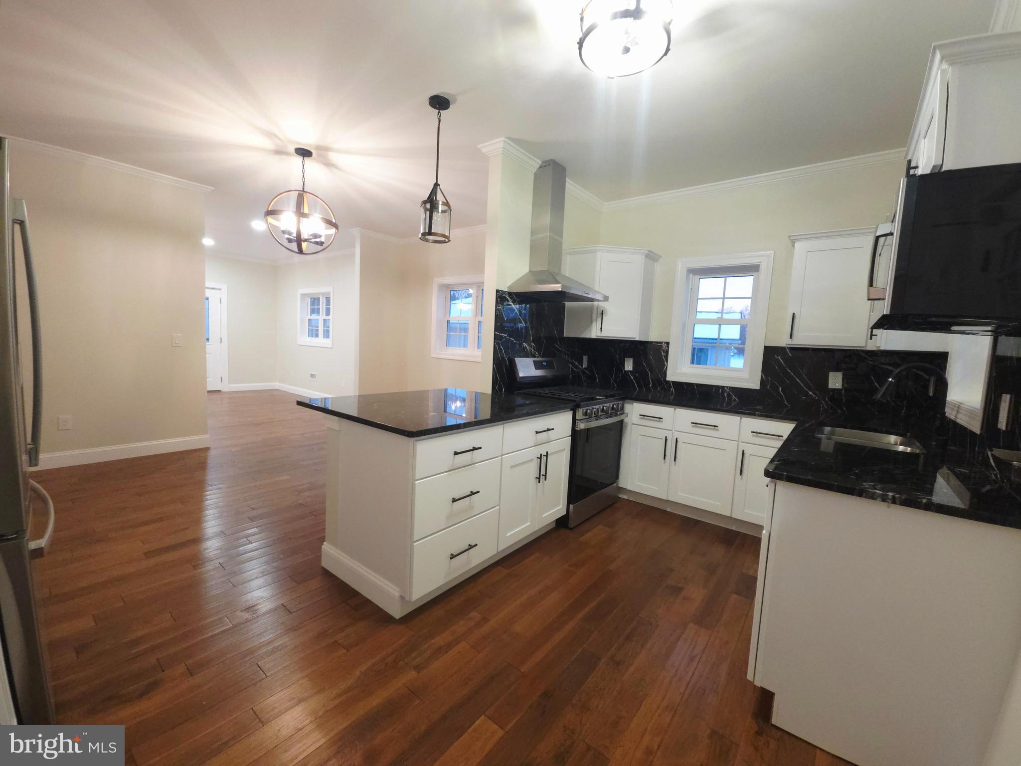 1015 Chambers Street Harrisburg, PA 17113 - Photo 8 of 23 a large kitchen with granite countertop a sink cabinets and wooden floor