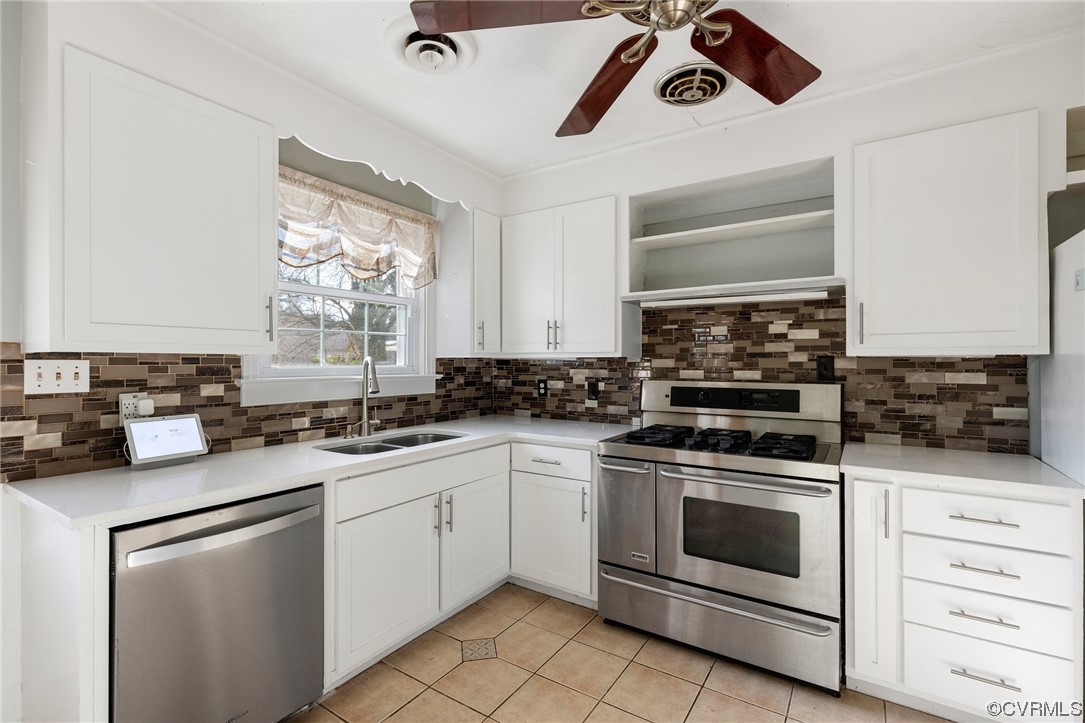 406 Riverside Avenue Hopewell, VA 23860 - Photo 13 of 38 a kitchen with a stove sink and cabinets