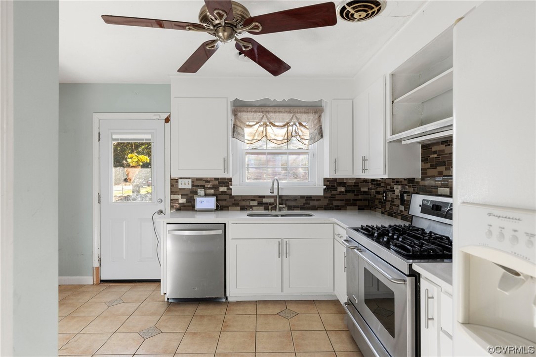 406 Riverside Avenue Hopewell, VA 23860 - Photo 14 of 38 a kitchen with a stove cabinets and window