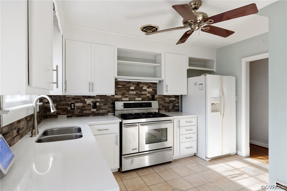 406 Riverside Avenue Hopewell, VA 23860 - Photo 15 of 38 a kitchen with stainless steel appliances a stove a microwave and white cabinets