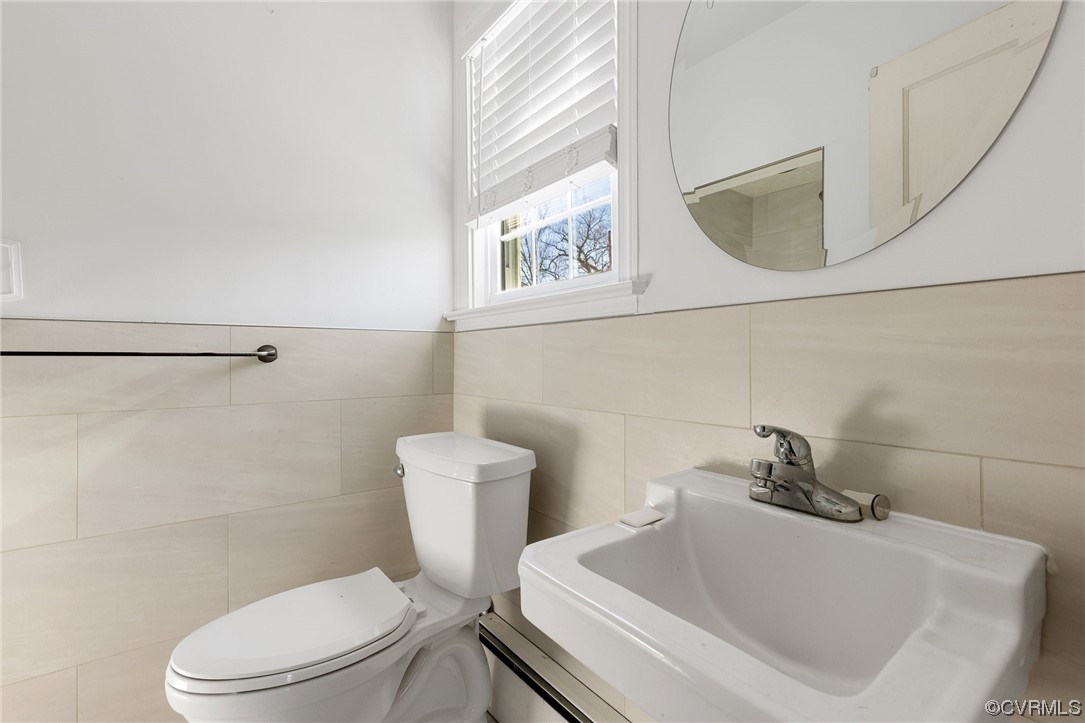 406 Riverside Avenue Hopewell, VA 23860 - Photo 18 of 38 a white toilet sitting next to a bathroom sink