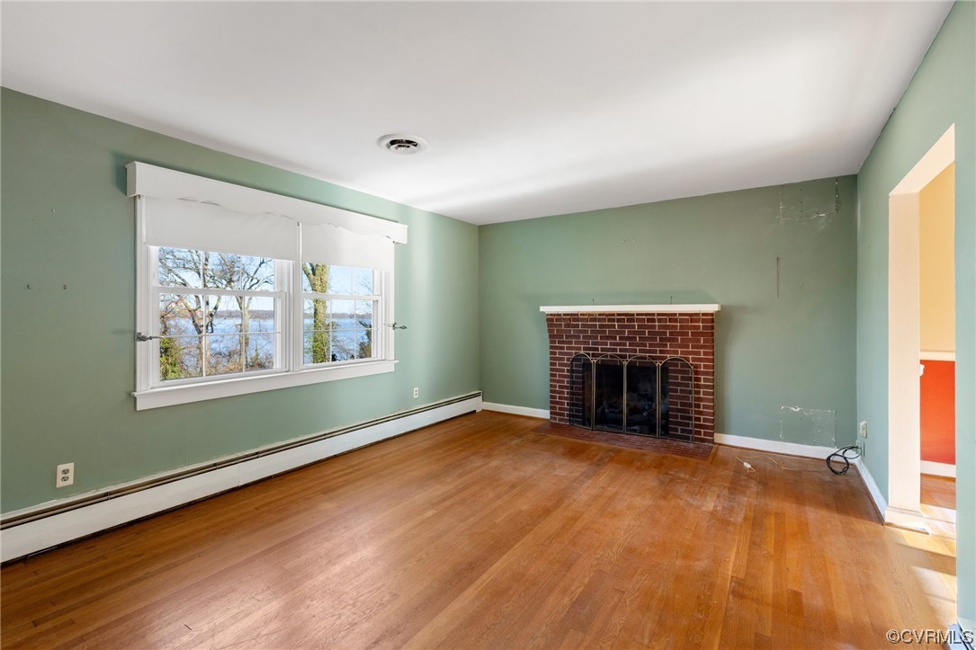 406 Riverside Avenue Hopewell, VA 23860 - Photo 7 of 38 an empty room with large windows and a fireplace