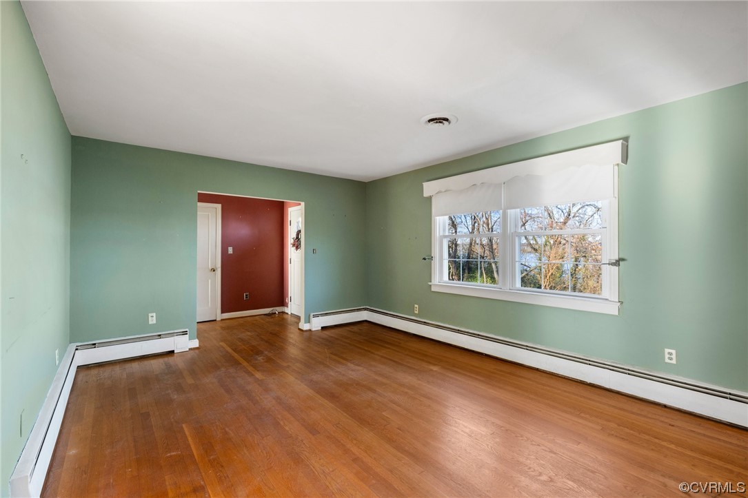 406 Riverside Avenue Hopewell, VA 23860 - Photo 8 of 38 a view of an empty room with window and wooden floor