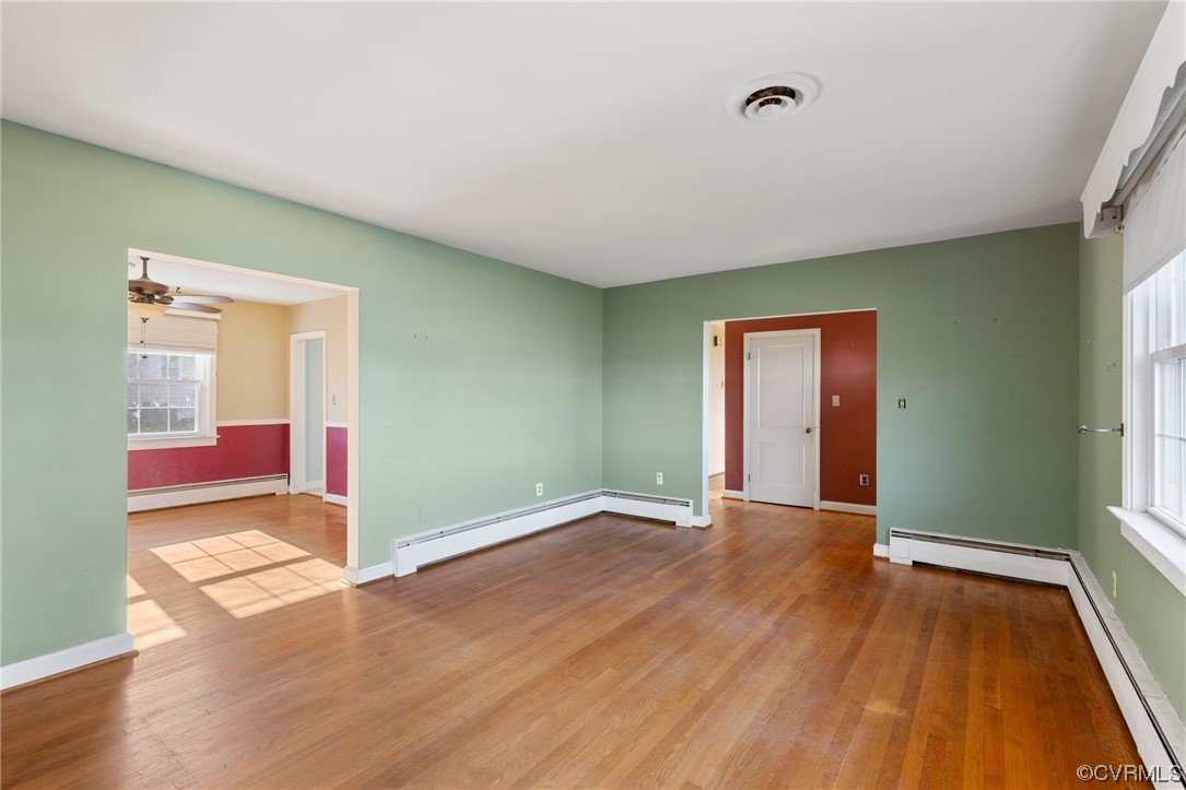 406 Riverside Avenue Hopewell, VA 23860 - Photo 9 of 38 an empty room with wooden floor and windows