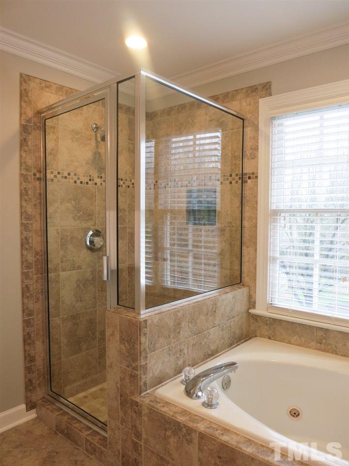 9305 Dawnshire Road Raleigh, NC 27615 - Photo 18 of 25 a bathroom with a bathtub and shower