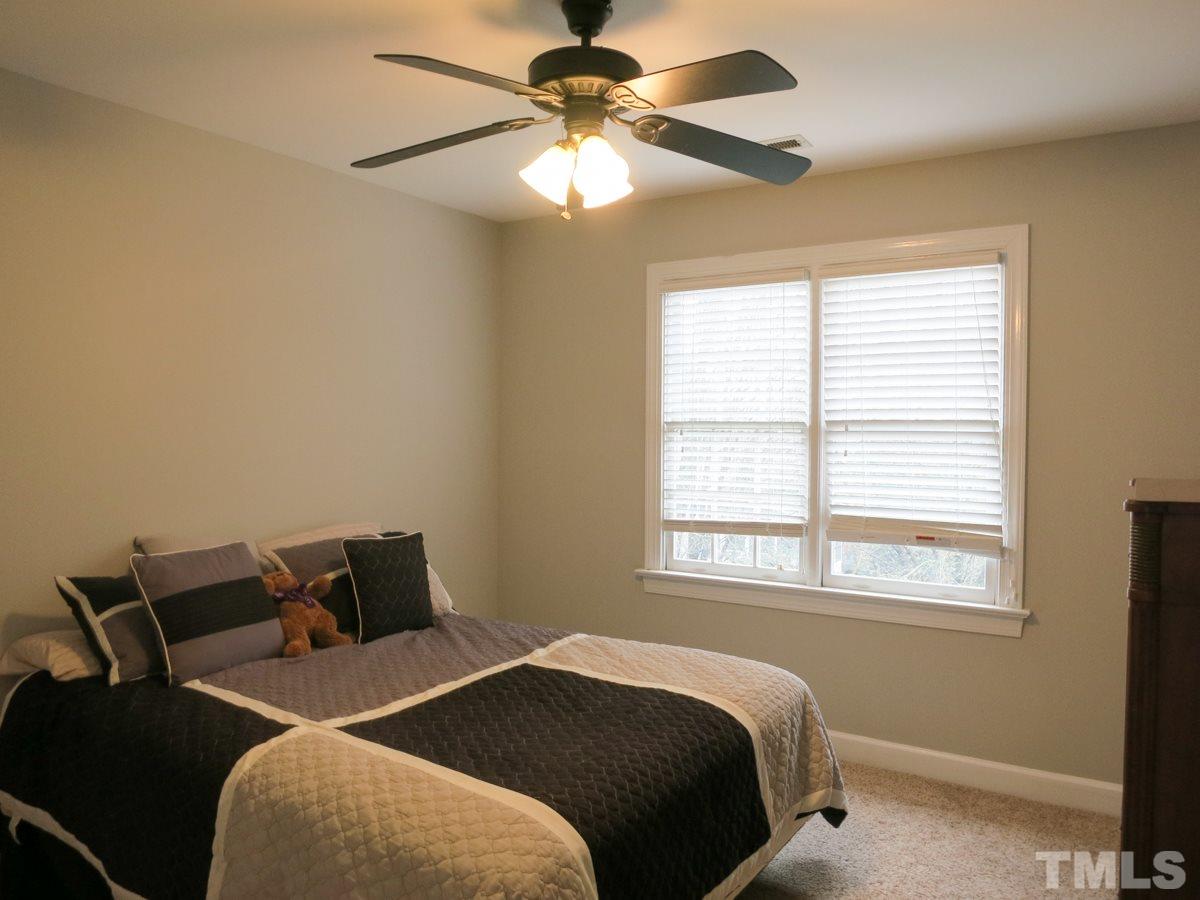 9305 Dawnshire Road Raleigh, NC 27615 - Photo 19 of 25 a bedroom with a bed and window