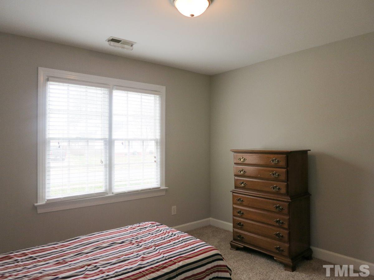 9305 Dawnshire Road Raleigh, NC 27615 - Photo 20 of 25 a bedroom with a bed and a window