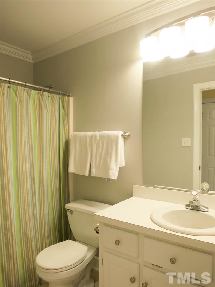 9305 Dawnshire Road Raleigh, NC 27615 - Photo 21 of 25 a bathroom with a sink a toilet and shower