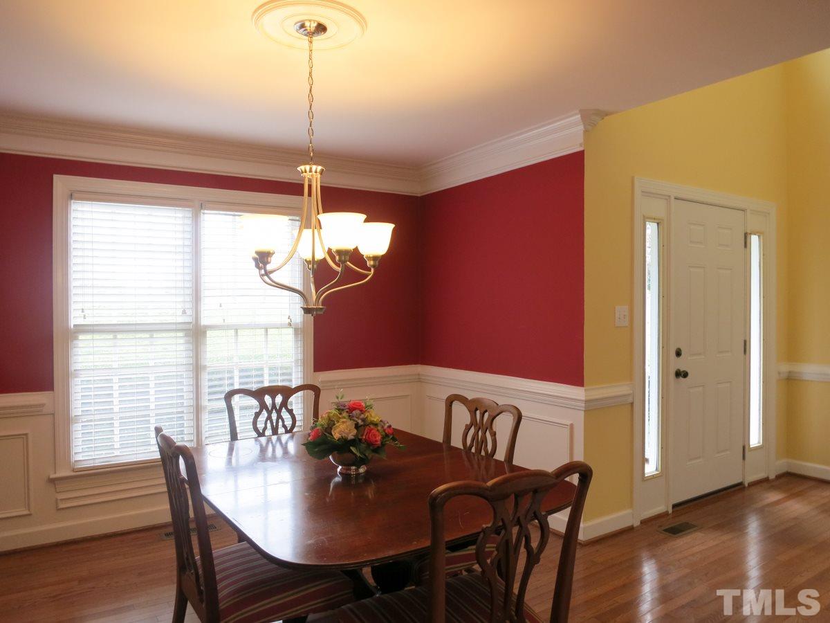 9305 Dawnshire Road Raleigh, NC 27615 - Photo 4 of 25 a view of a dining room with furniture window and wooden floor