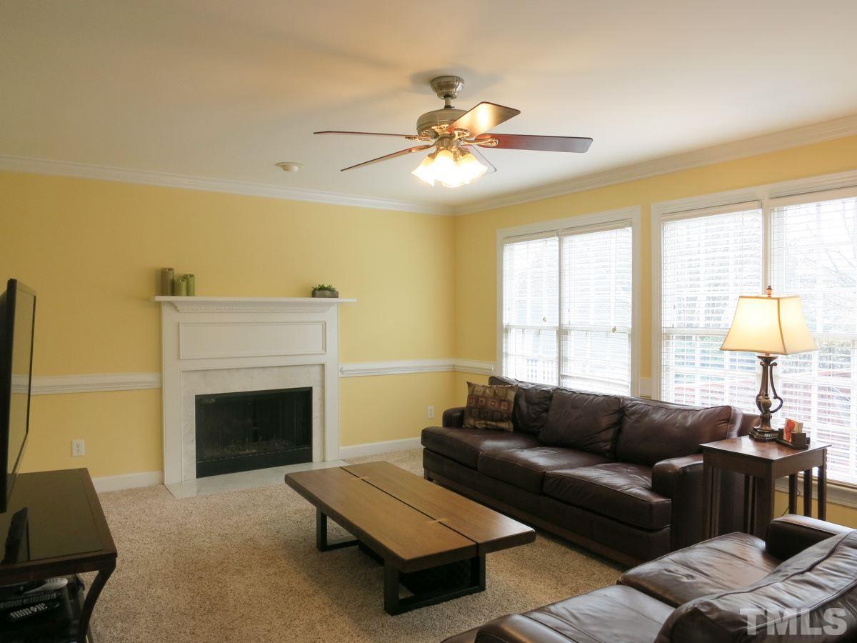 9305 Dawnshire Road Raleigh, NC 27615 - Photo 5 of 25 a living room with furniture and a fireplace