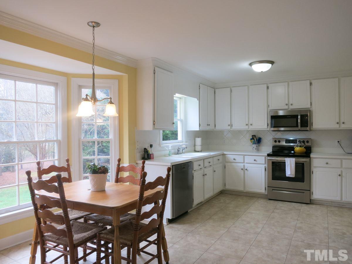 9305 Dawnshire Road Raleigh, NC 27615 - Photo 8 of 25 a kitchen with kitchen island granite countertop a sink a center island and appliances