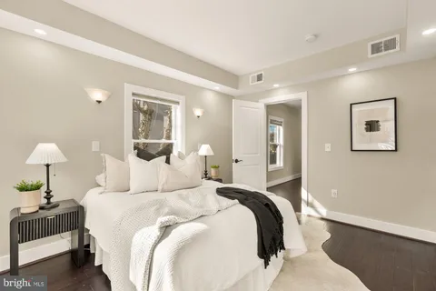 a bedroom with a bed and a lamp
