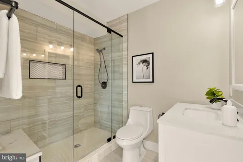 a bathroom with a sink toilet and shower