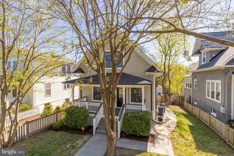 a yellow house with trees in front of it