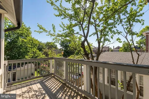 a balcony with wooden floor and fence