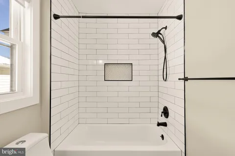 a bathroom with a bathtub and shower