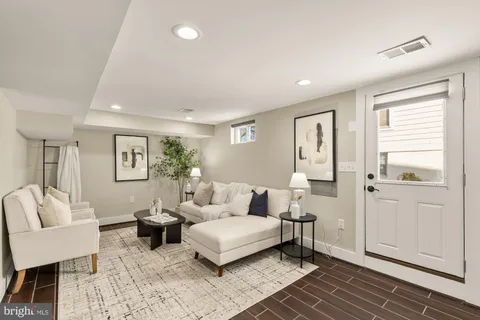 a living room with furniture and wooden floor