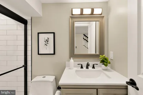 a bathroom with a sink a mirror and a toilet
