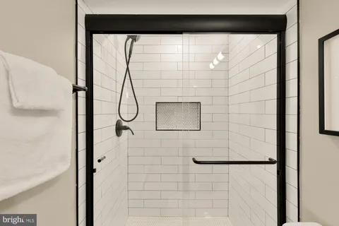 a bathroom with a glass shower door