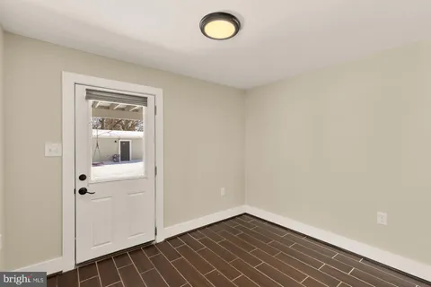 a view of a livingroom with wooden floor and a table