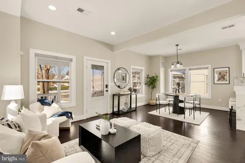 a living room with furniture and wooden floor
