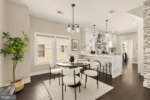 a dining room with furniture and wooden floor
