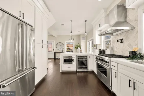 a kitchen with stainless steel appliances a stove a sink and a refrigerator