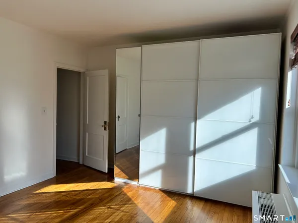 a kitchen with granite countertop stainless steel appliances and wooden floor