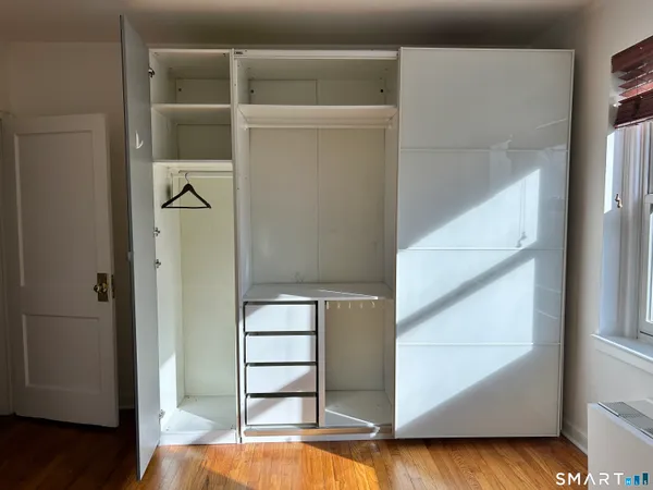 a view of walk in closet with empty racks