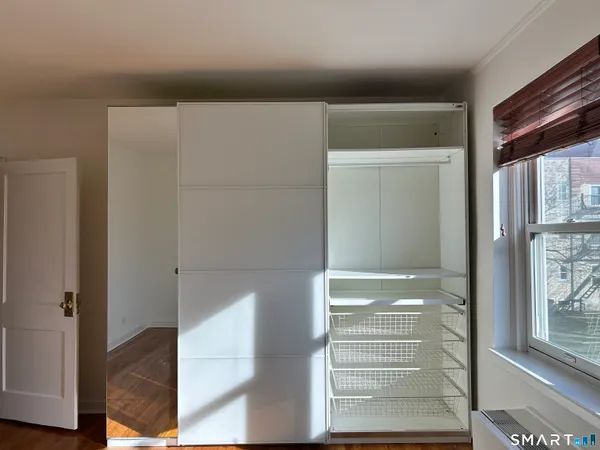 a view of walk in closet with empty racks