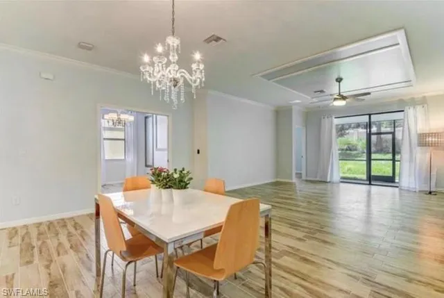 a view of a dining room with furniture window and wooden floor
