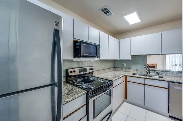 a kitchen with a sink stove and microwave
