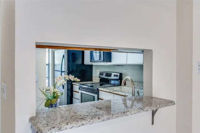 a kitchen with a stove a microwave and refrigerator