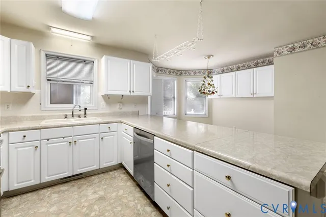a kitchen with granite countertop white cabinets white appliances and sink
