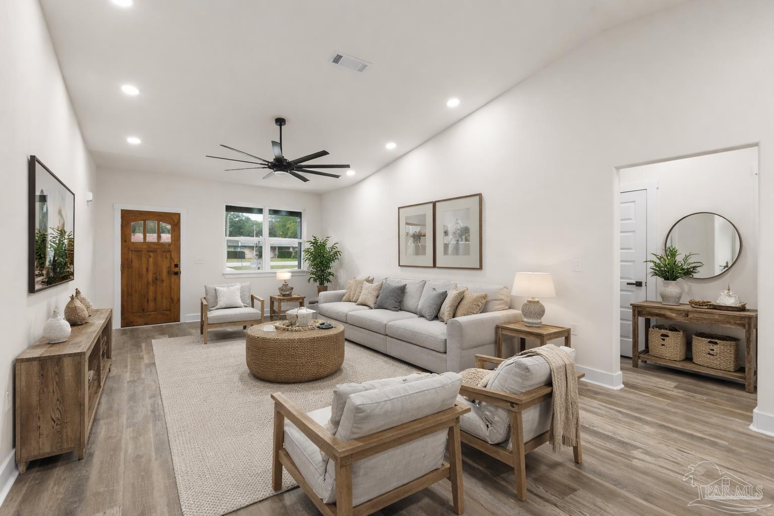5005 Saufley Field Road Pensacola, FL 32526 - Photo 4 of 27 a living room with fireplace furniture and a wooden floor