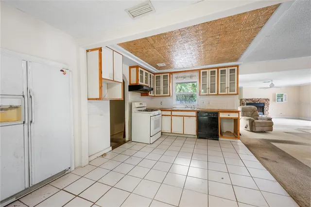 a kitchen with a sink a stove and cabinets