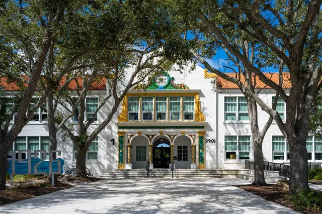 a view of a lake with a yard and large trees