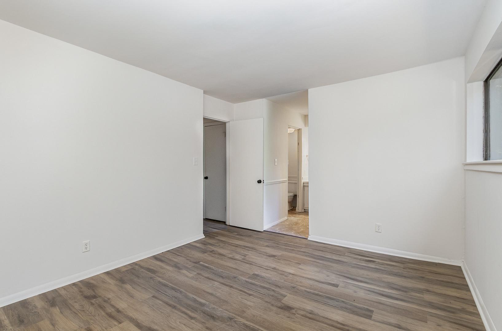 1130 Schaub Drive, Unit C Raleigh, NC 27606 - Photo 16 of 25 a view of an empty room with wooden floor