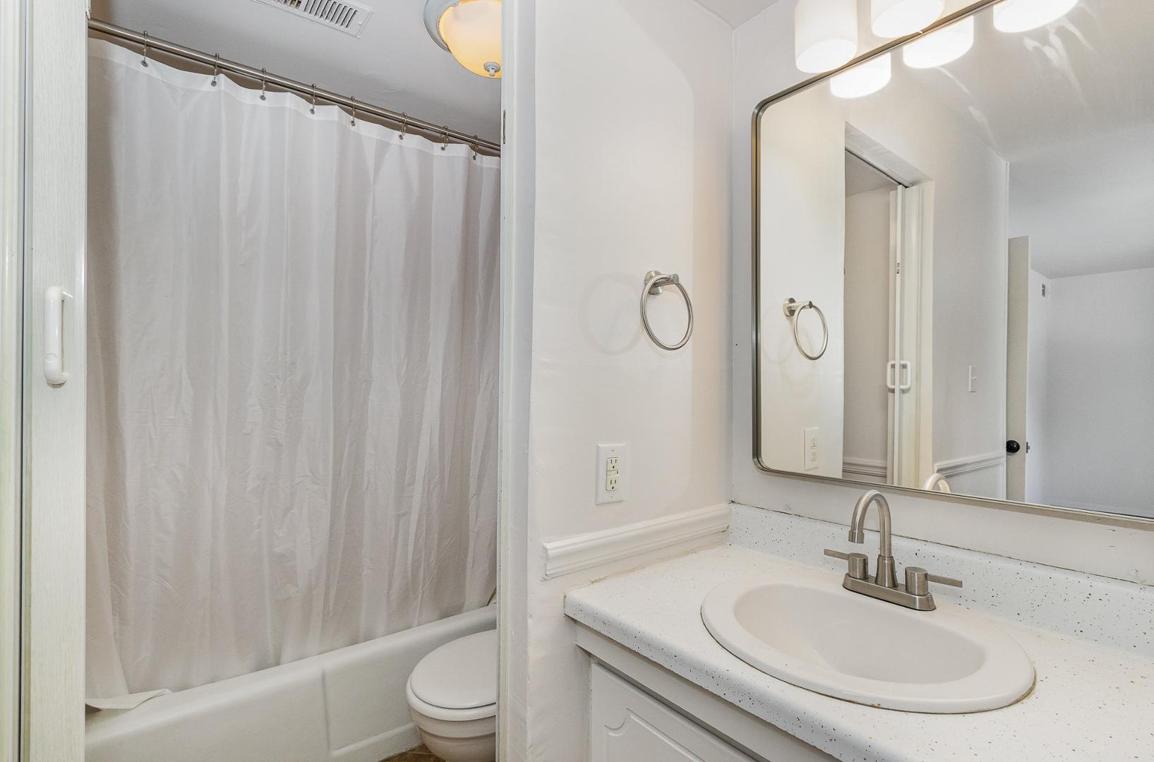 1130 Schaub Drive, Unit C Raleigh, NC 27606 - Photo 18 of 25 a bathroom with a sink toilet and shower