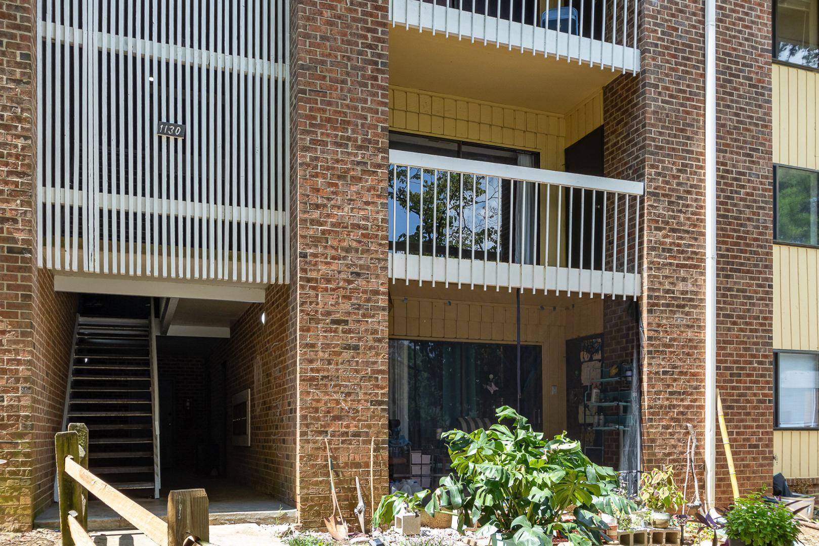 1130 Schaub Drive, Unit C Raleigh, NC 27606 - Photo 21 of 25 a front view of a house with a garden