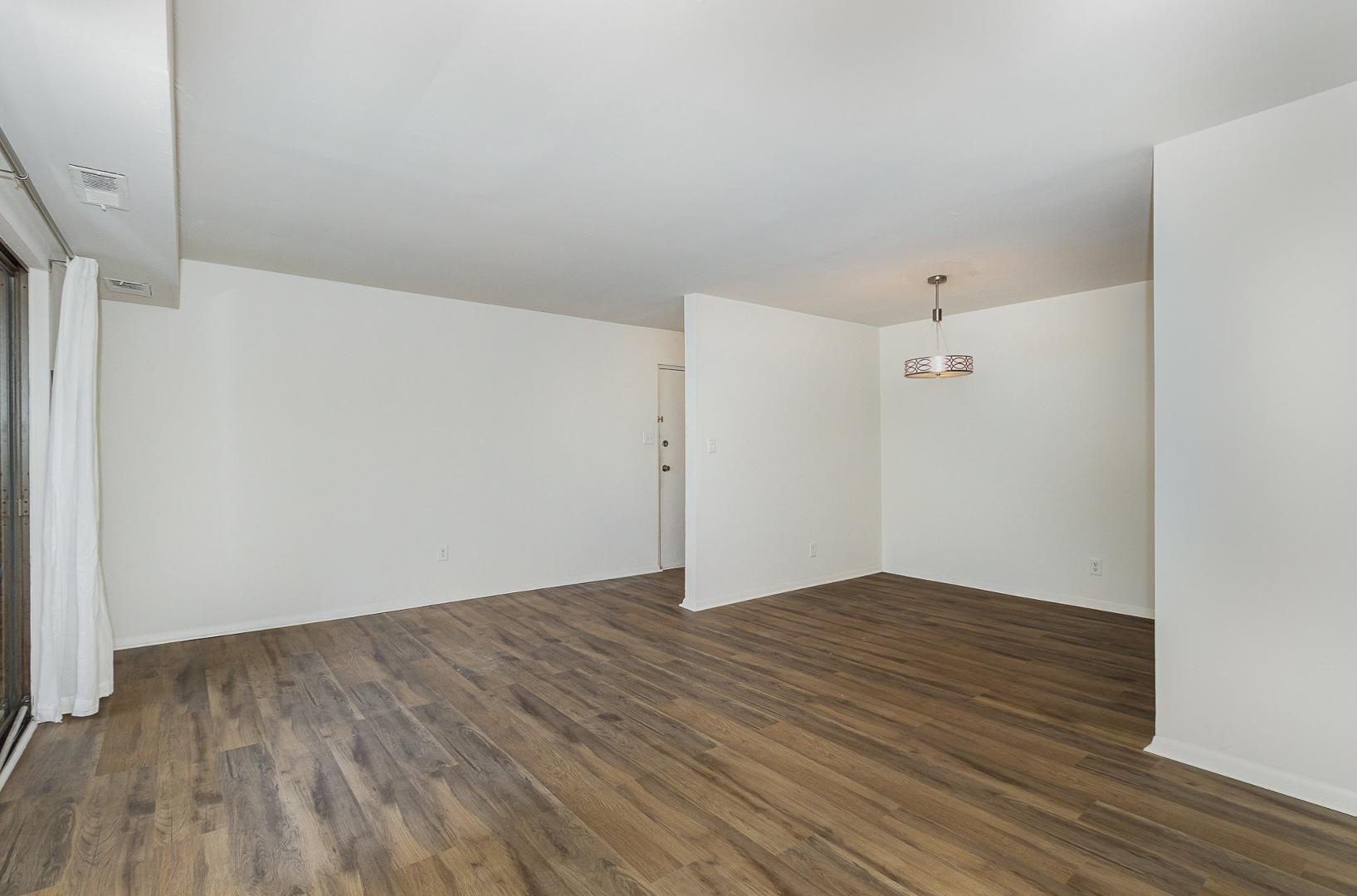 1130 Schaub Drive, Unit C Raleigh, NC 27606 - Photo 4 of 25 a view of an empty room with wooden floor