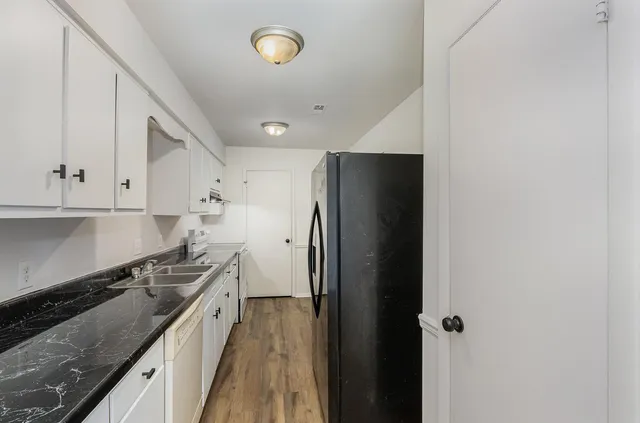 a kitchen with stainless steel appliances a refrigerator and a stove