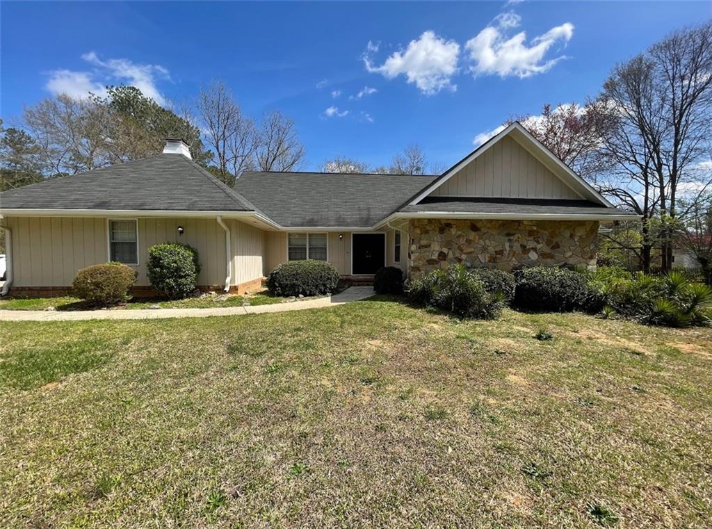 7975 Woods Road Fairburn, GA 30213 - Photo 1 of 1 a front view of a house with a yard