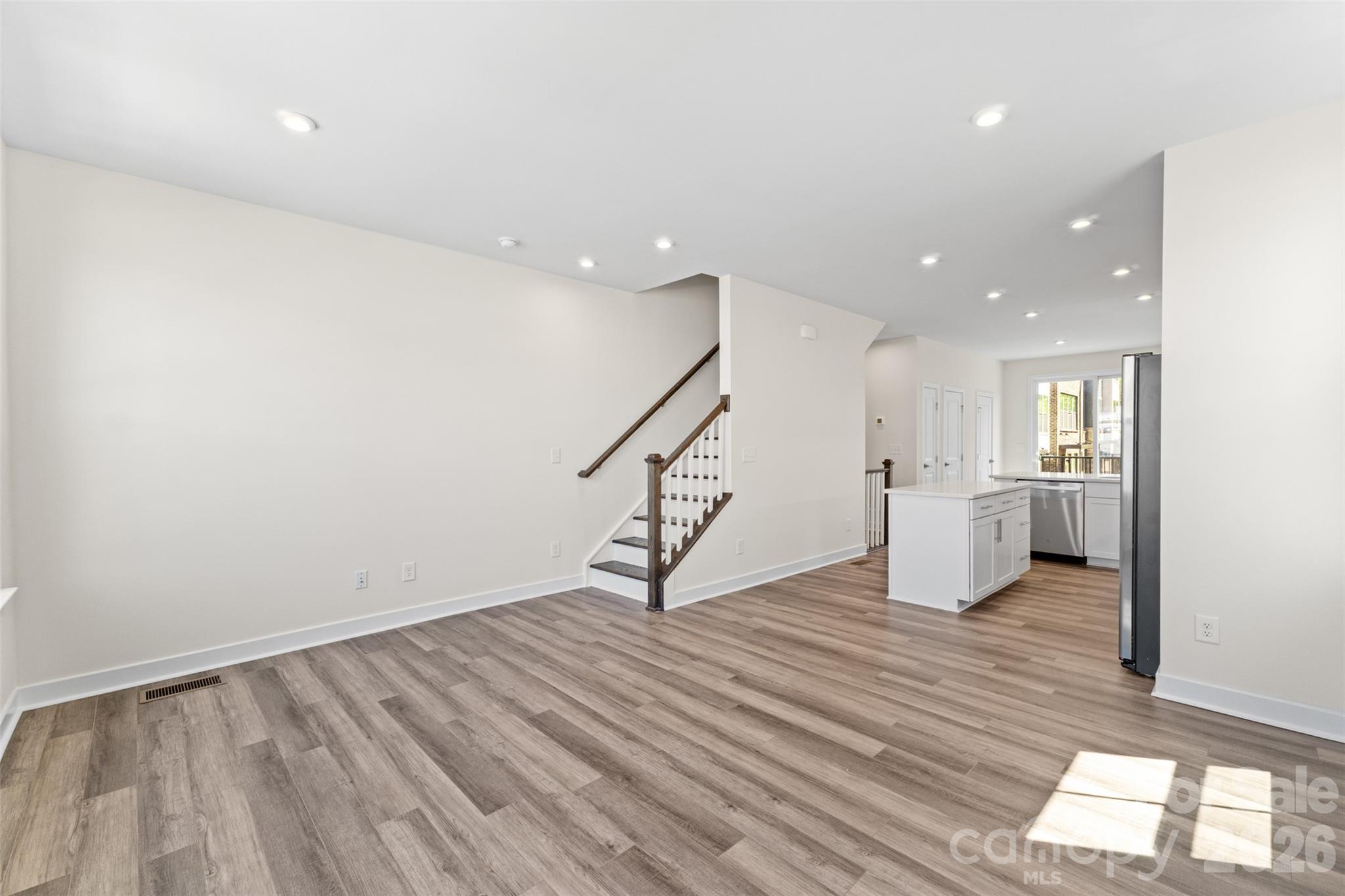 3645 South Tryon Street Charlotte, NC 28217 - Photo 13 of 45 a view of an empty room with wooden floor and a window