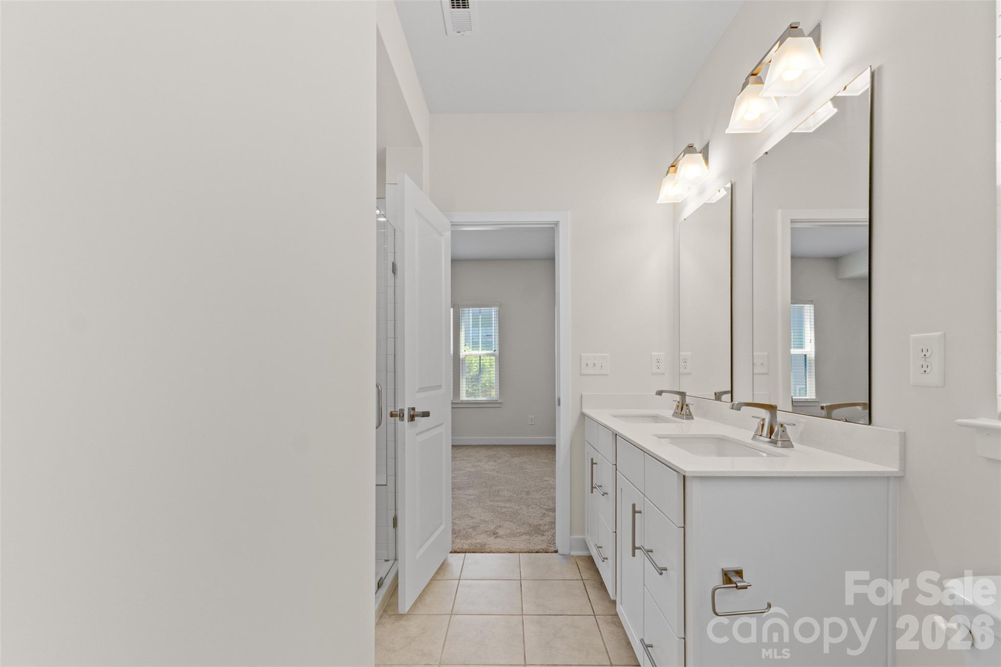 3645 South Tryon Street Charlotte, NC 28217 - Photo 21 of 45 a bathroom with a double vanity sink a mirror and a shower