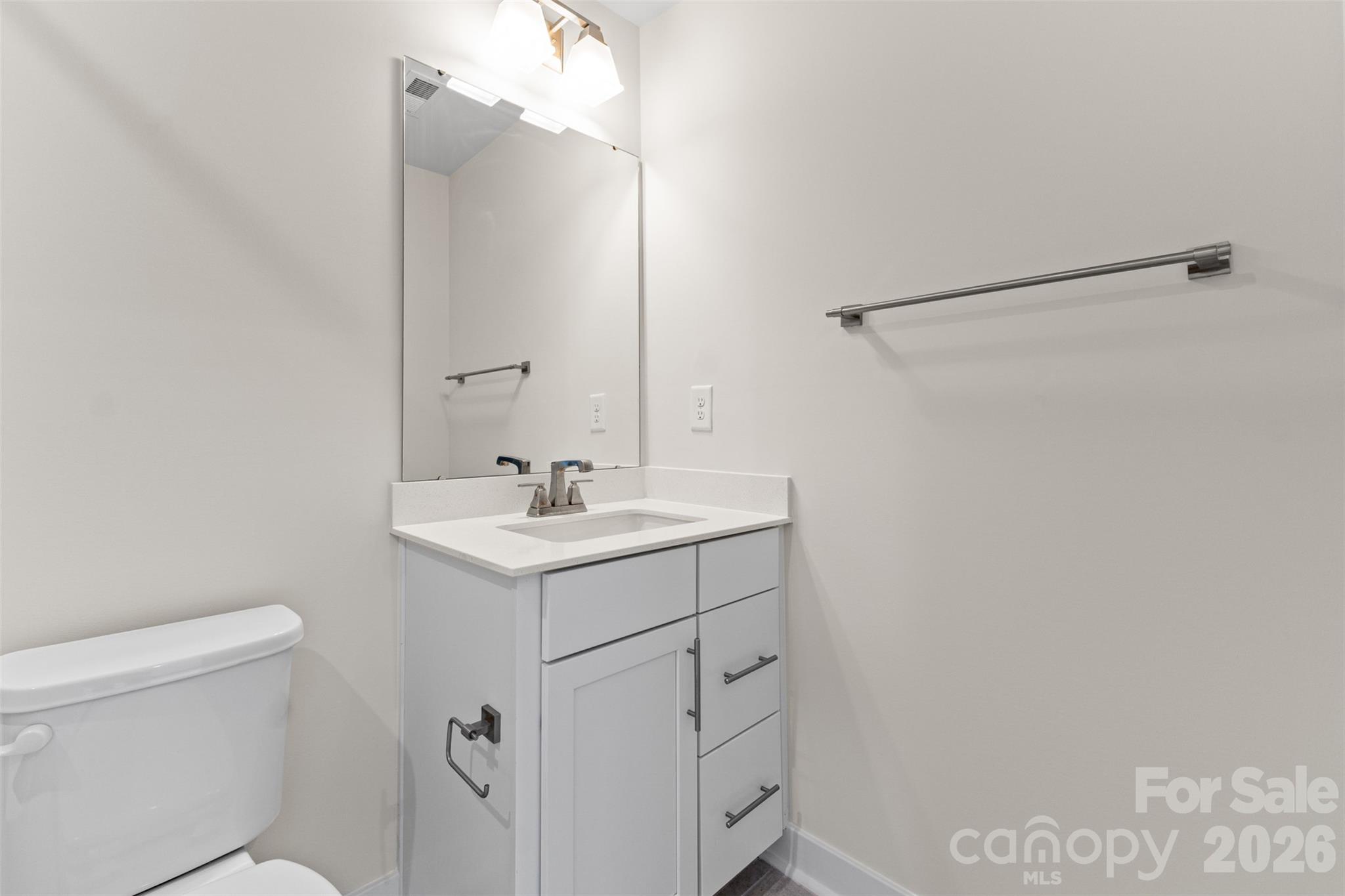 3645 South Tryon Street Charlotte, NC 28217 - Photo 24 of 45 a bathroom with a sink mirror vanity and toilet