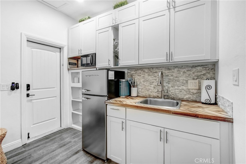 9732 Belmont Drive Riverside, CA 92503 - Photo 13 of 20 a kitchen with stainless steel appliances granite countertop a sink a refrigerator and cabinets