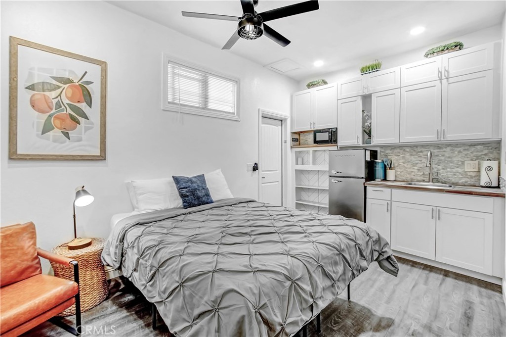 9732 Belmont Drive Riverside, CA 92503 - Photo 14 of 20 a bedroom with a bed a desk and chair