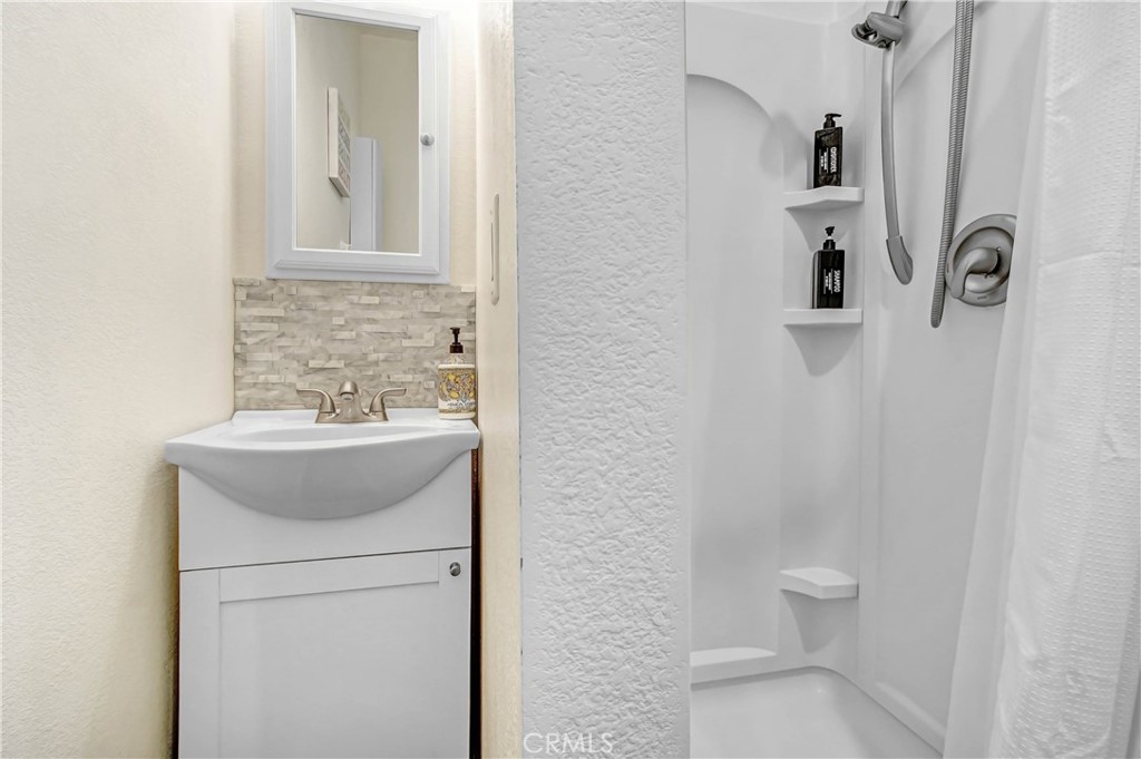 9732 Belmont Drive Riverside, CA 92503 - Photo 16 of 20 a bathroom with a sink a toilet and shower
