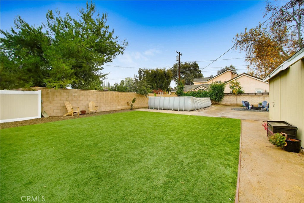 9732 Belmont Drive Riverside, CA 92503 - Photo 18 of 20 a view of yard with swimming pool and green space